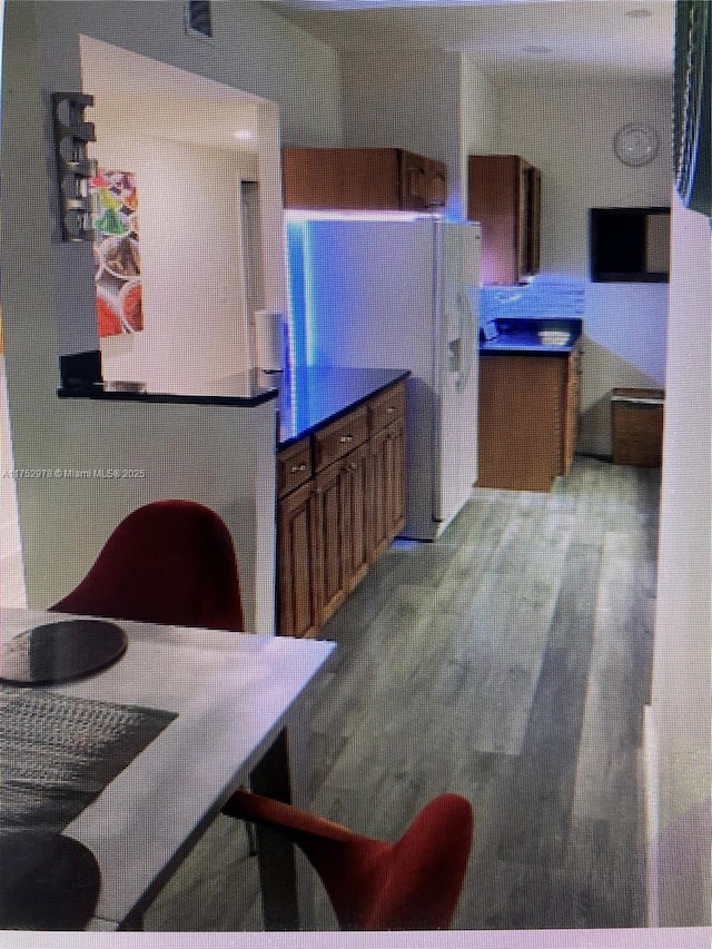 kitchen featuring brown cabinets and wood finished floors