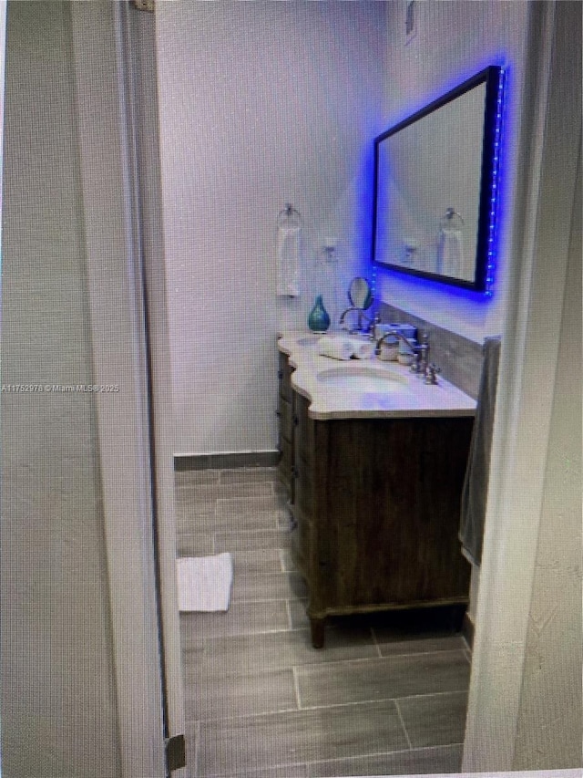 bathroom with wood finish floors and vanity