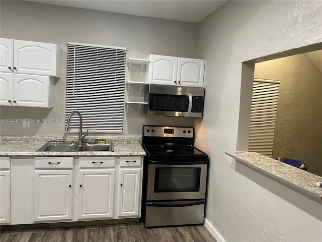 kitchen with dark wood-style floors, stainless steel appliances, white cabinetry, open shelves, and a sink