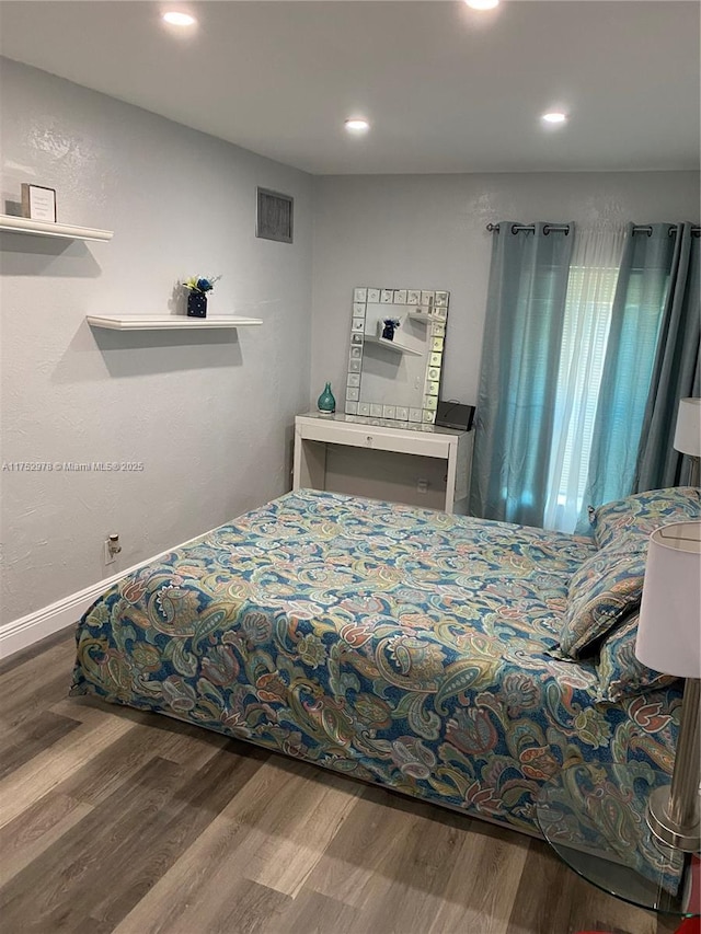 bedroom featuring recessed lighting, wood finished floors, visible vents, and baseboards