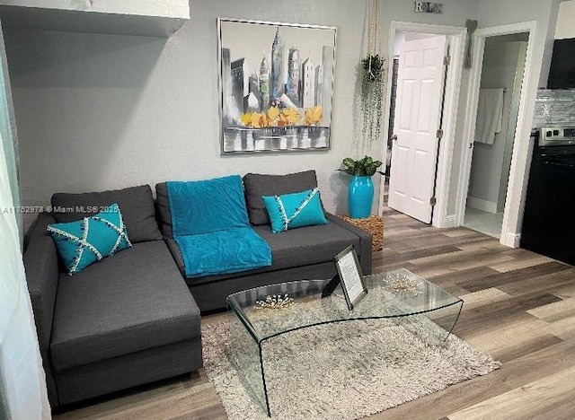 living room featuring wood finished floors and baseboards