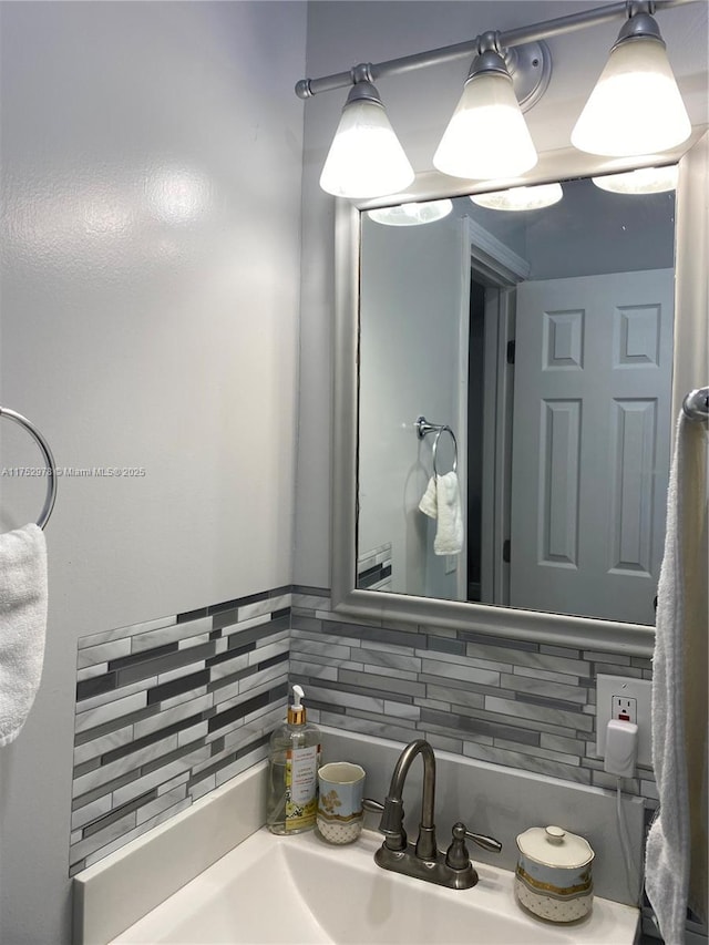 bathroom with a sink and backsplash