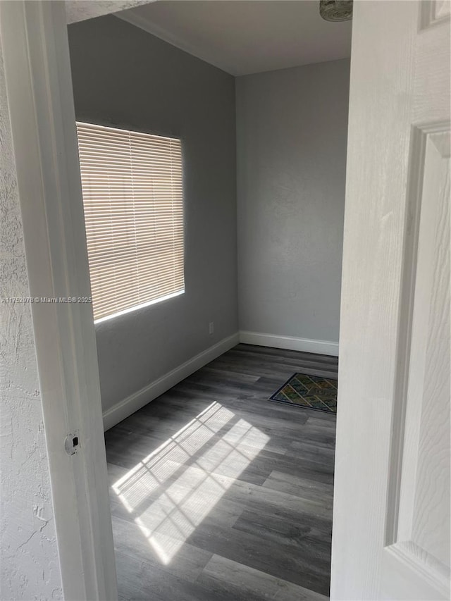 spare room with visible vents, baseboards, and wood finished floors