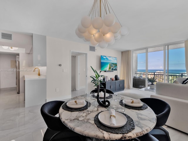 dining room with marble finish floor, expansive windows, and visible vents