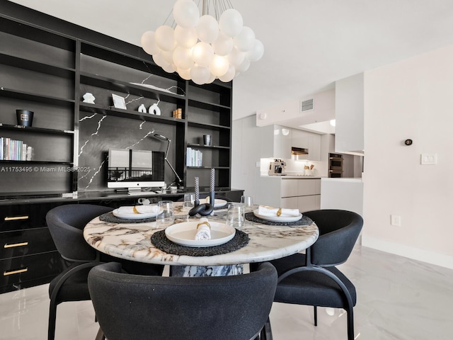 dining area with baseboards, built in features, visible vents, and a notable chandelier