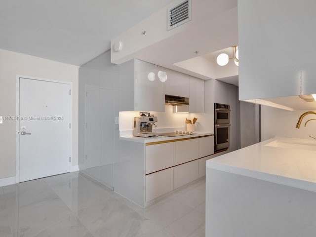 kitchen with black electric stovetop, visible vents, double oven, a sink, and modern cabinets