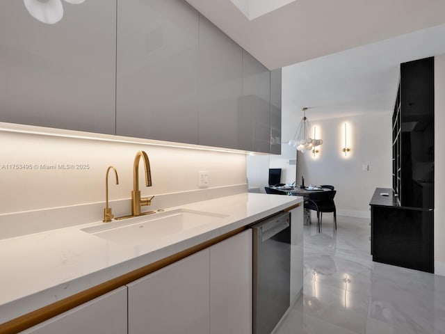 kitchen featuring a sink, white cabinetry, light countertops, stainless steel dishwasher, and modern cabinets