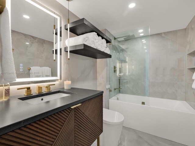 bathroom featuring recessed lighting, tile walls, toilet, and shower / bathtub combination