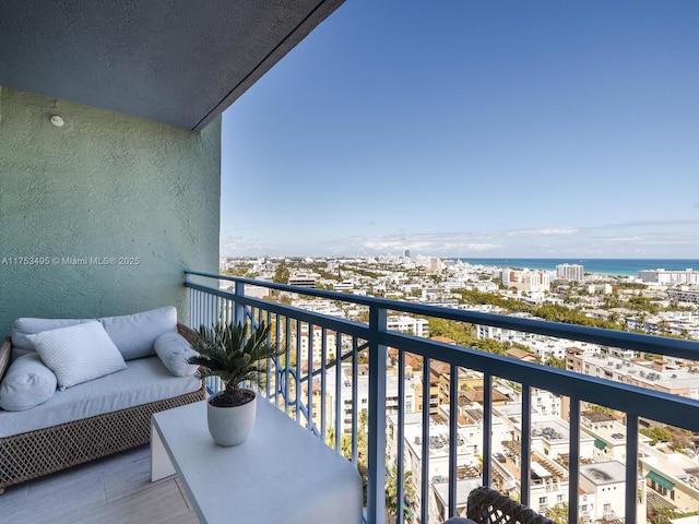 balcony with a water view and a city view