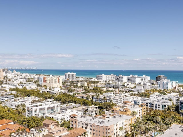 birds eye view of property with a water view and a city view
