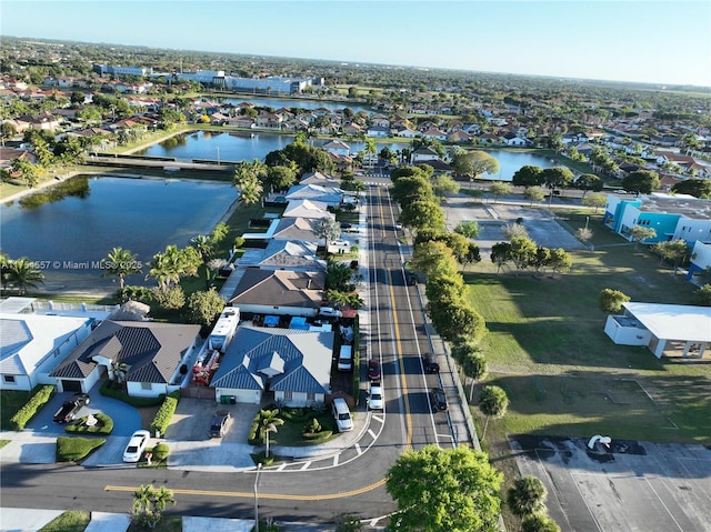 birds eye view of property with a water view and a residential view