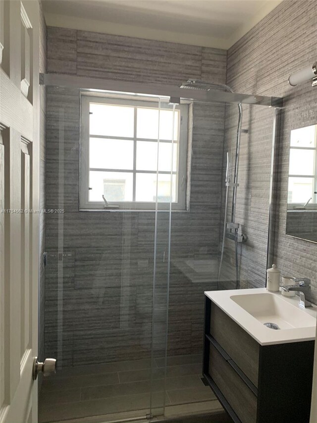 bathroom featuring a stall shower, plenty of natural light, and vanity