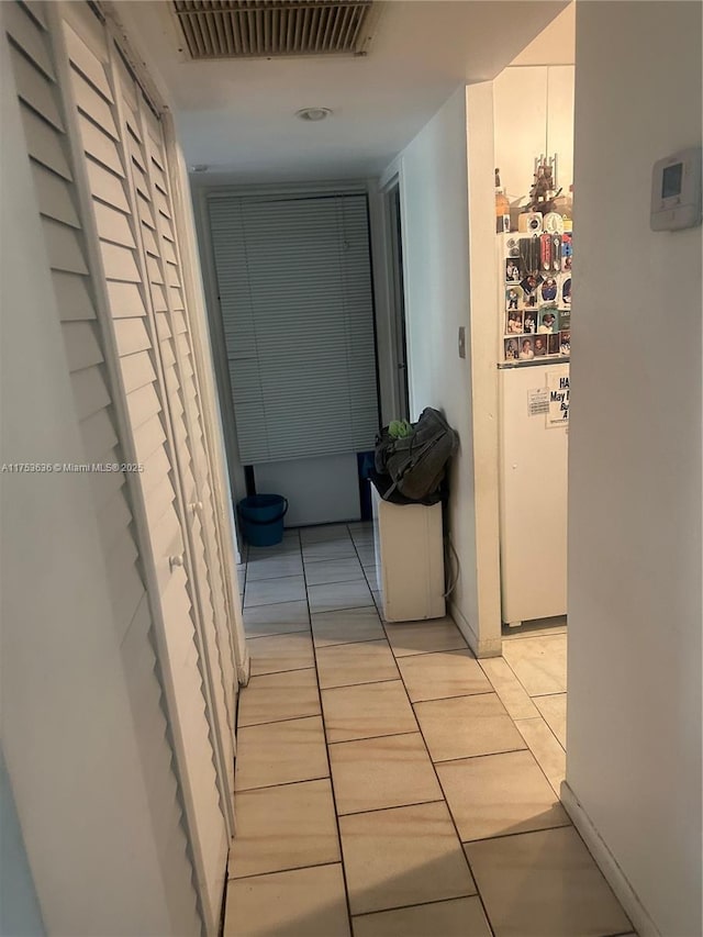 corridor with light tile patterned floors and visible vents