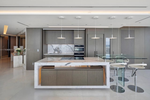 kitchen featuring black electric cooktop, gray cabinetry, a sink, a large island, and modern cabinets