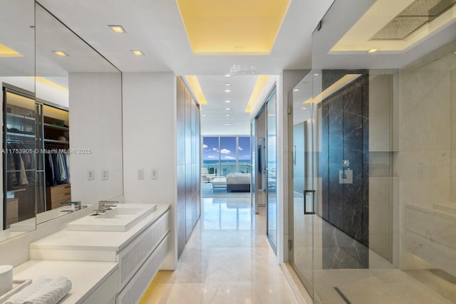 full bathroom featuring ensuite bath, expansive windows, vanity, a shower stall, and recessed lighting