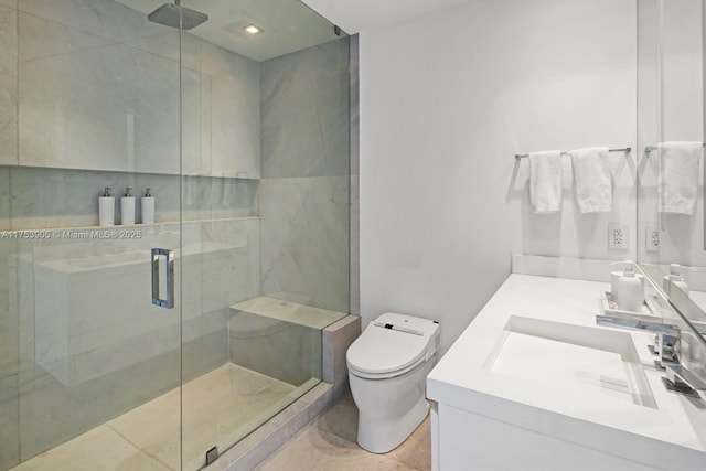 bathroom featuring vanity, a shower stall, and toilet