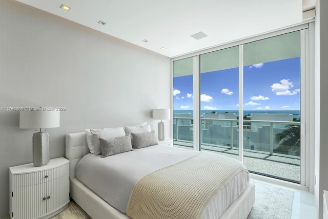 bedroom featuring a wall of windows and access to outside