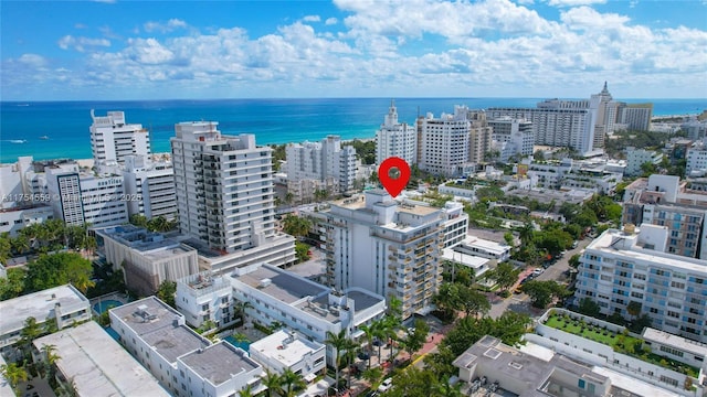 drone / aerial view featuring a view of city and a water view