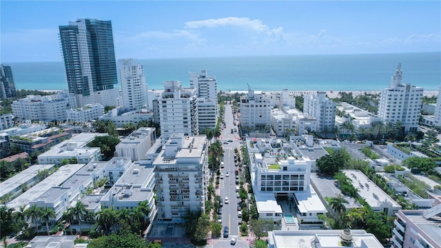 birds eye view of property with a water view and a city view