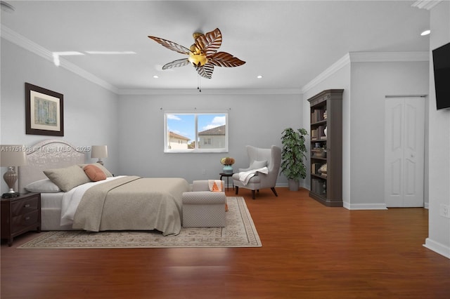 bedroom with crown molding, recessed lighting, wood finished floors, and baseboards