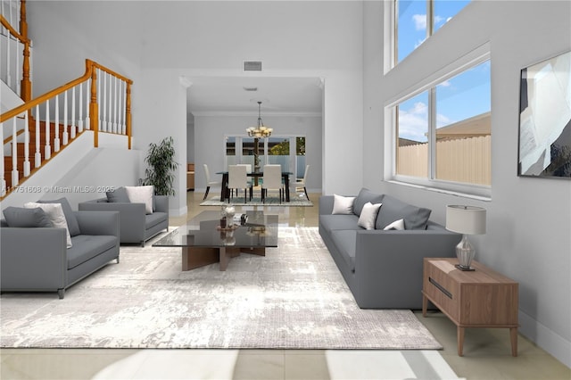living room with visible vents, a healthy amount of sunlight, crown molding, and a chandelier