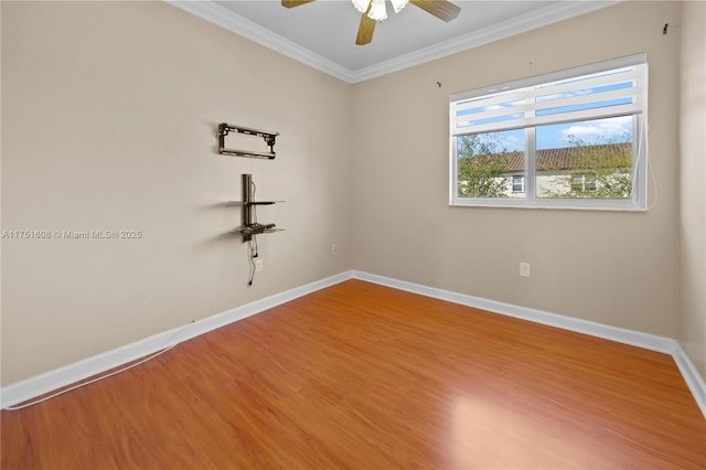 unfurnished room with ornamental molding, ceiling fan, wood finished floors, and baseboards
