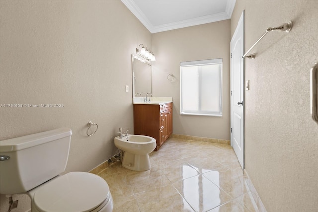 bathroom with baseboards, toilet, crown molding, vanity, and a bidet