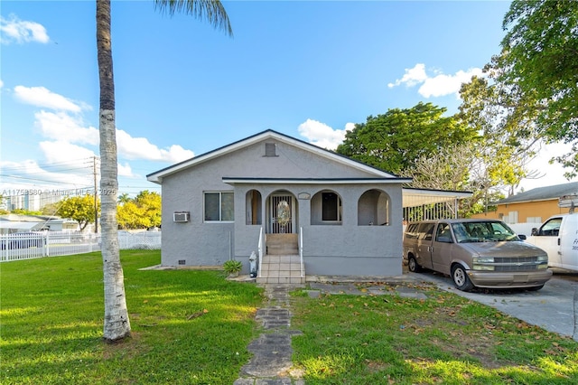 bungalow featuring crawl space, fence, a front lawn, a carport, and stucco siding