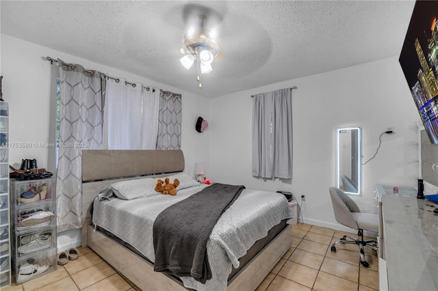 tiled bedroom featuring a textured ceiling and ceiling fan