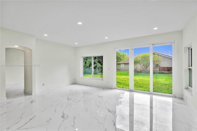 empty room with marble finish floor and recessed lighting