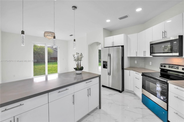 kitchen with marble finish floor, visible vents, backsplash, appliances with stainless steel finishes, and white cabinetry