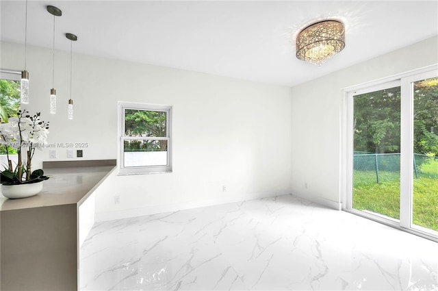 interior space featuring marble finish floor and baseboards