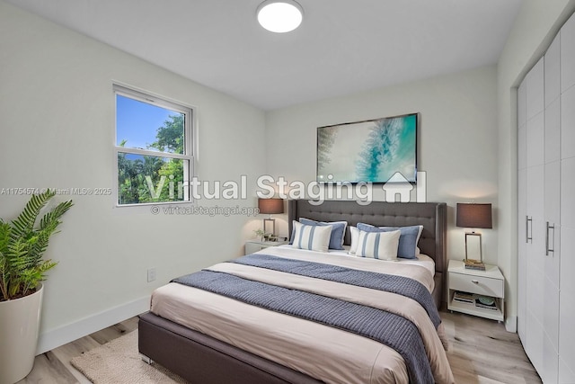 bedroom with wood finished floors and baseboards