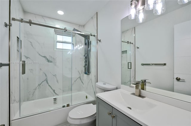 full bath featuring combined bath / shower with glass door, vanity, and toilet