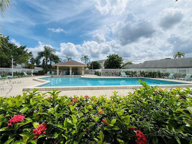 pool featuring a patio area and fence