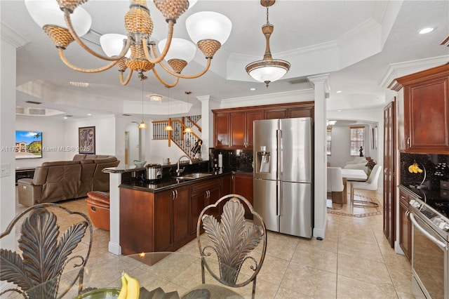 kitchen with a peninsula, a sink, appliances with stainless steel finishes, a tray ceiling, and dark countertops