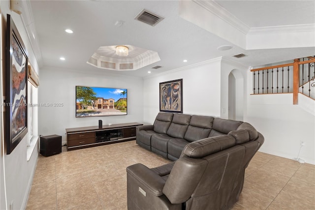 cinema with visible vents, a raised ceiling, arched walkways, ornamental molding, and recessed lighting