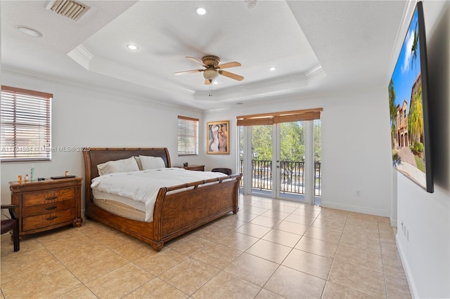 bedroom with access to outside, multiple windows, visible vents, and a raised ceiling