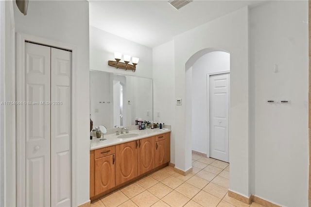 full bath with tile patterned flooring, a closet, visible vents, and vanity