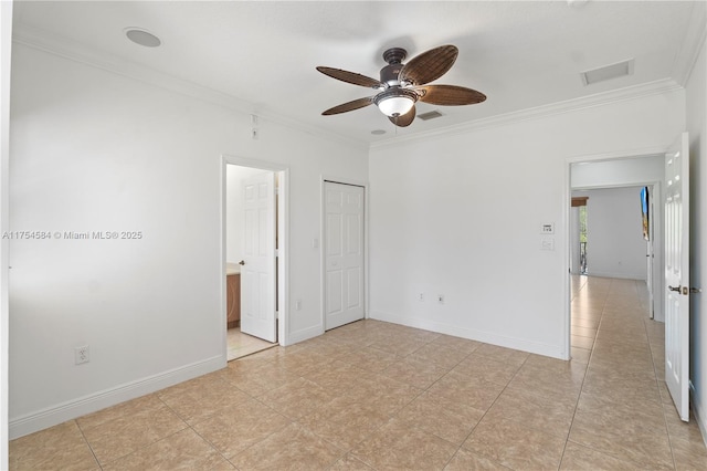 unfurnished bedroom with crown molding, light tile patterned floors, visible vents, ensuite bathroom, and baseboards