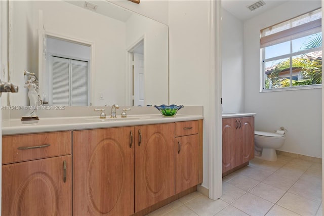 bathroom featuring tile patterned flooring, visible vents, vanity, and toilet