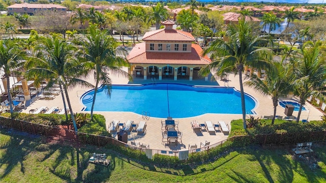 view of swimming pool featuring a patio and fence