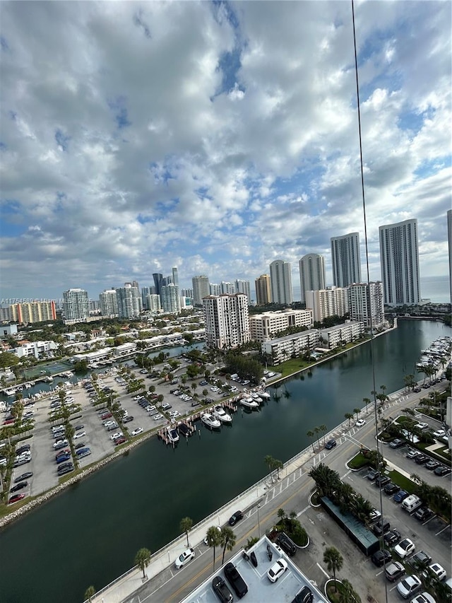 drone / aerial view featuring a view of city and a water view