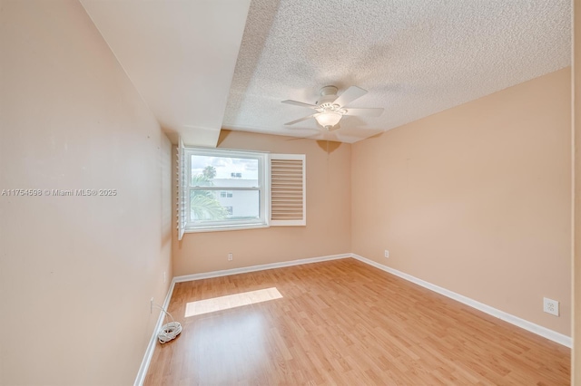 unfurnished room with light wood-style flooring, baseboards, ceiling fan, and a textured ceiling