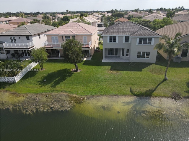 drone / aerial view featuring a residential view and a water view