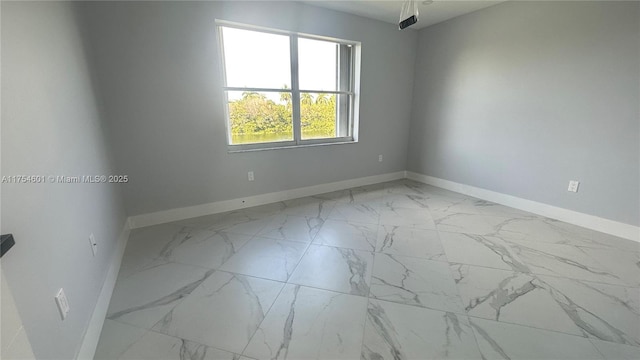 empty room with marble finish floor and baseboards