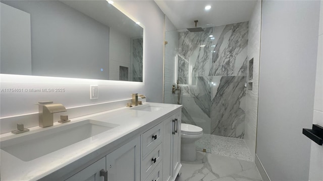 bathroom featuring marble finish floor, a marble finish shower, a sink, and toilet