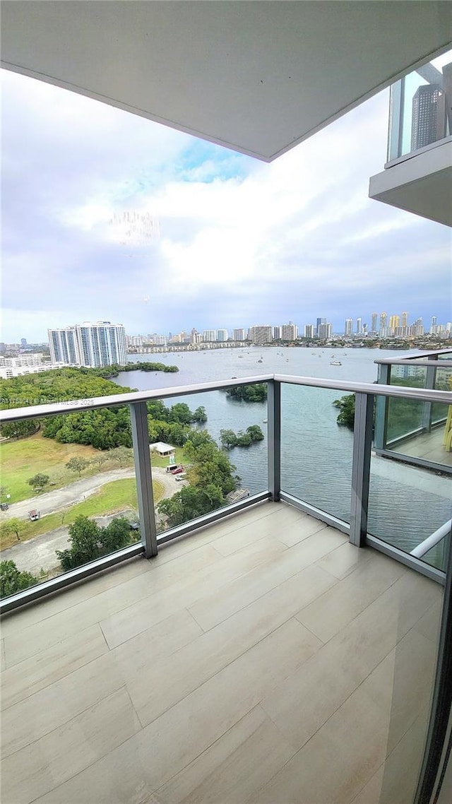 balcony featuring a view of city and a water view