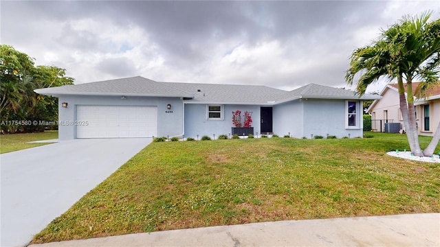 ranch-style home with a garage, concrete driveway, a front lawn, and stucco siding