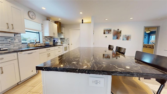 kitchen featuring decorative backsplash, white appliances, recessed lighting, and a sink